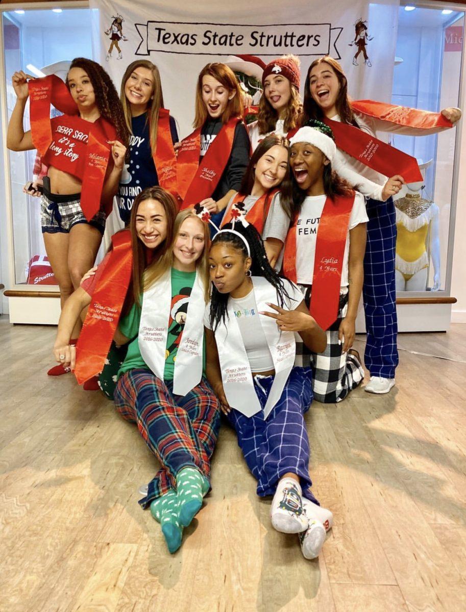 The Texas State Strutter seniors gather in their PJ’s and graduation stoles at the strutters annual holiday party in the Linda Gregg Fields Strutter Gallery.