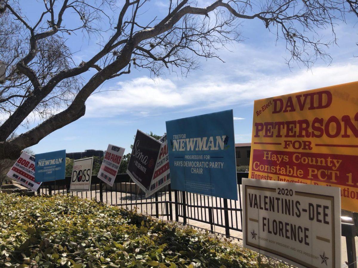 Election campaign signs are placed Friday, Feb. 28, 2020, outside the LBJ Student Center.