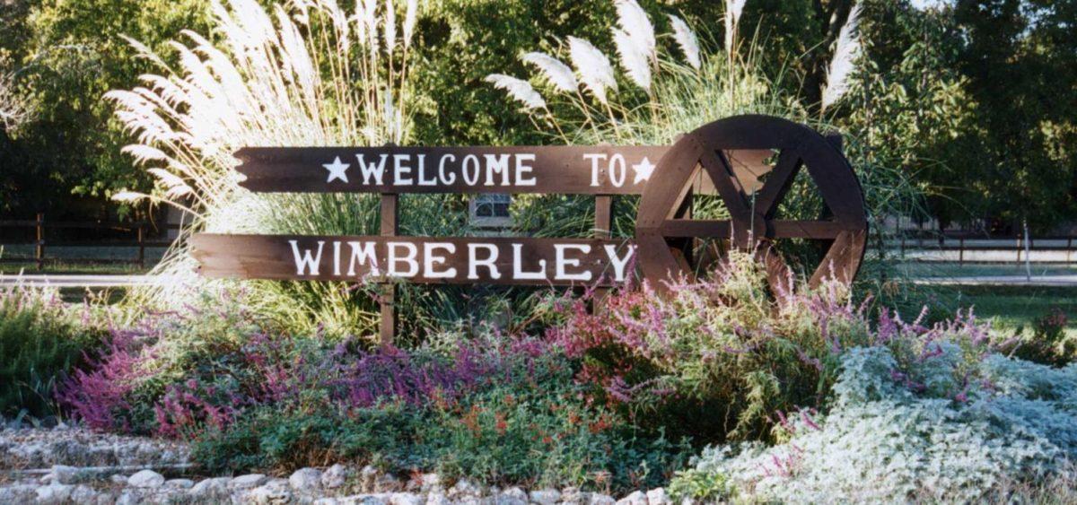 Welcome signage visible when entering Wimberley, Texas.