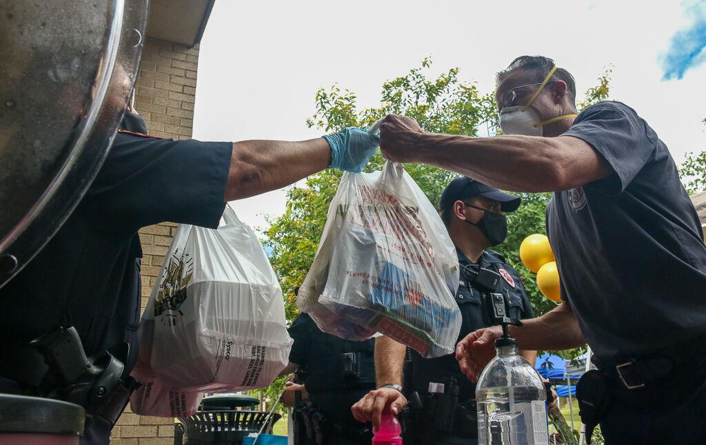 Texas State University Police Department Chief of Police Laurie Clouse hands out food to Hays County first responders, Thursday, May 14, 2020, at Harris Dining Hall.