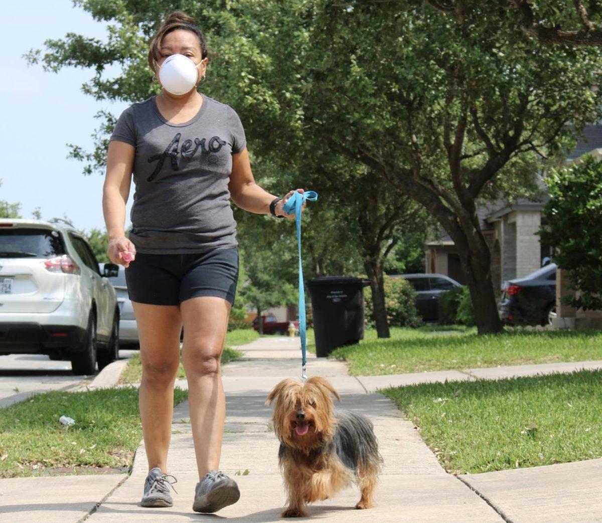 Ruth+Thompson+walks+her+dog+around+the+neighborhood%2C+Tuesday%2C+April+21%2C+2020%2C+in+San+Antonio%2C+Texas.+San+Antonio+has+mandated+citizens+to+wear+either+face+coverings+or+masks+while+in+public.