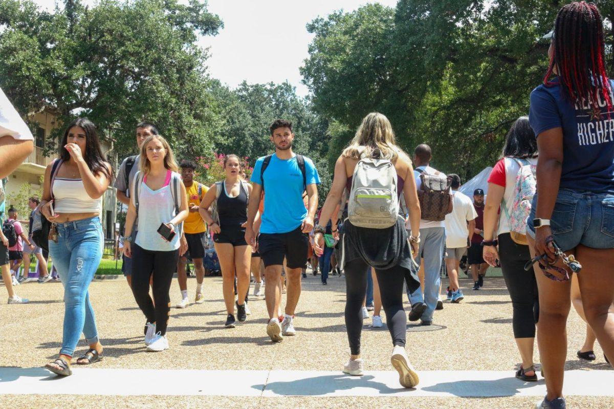 Texas State students walk to and from classes on the first day of school, Monday, Aug. 26, 2019, near the Quad.