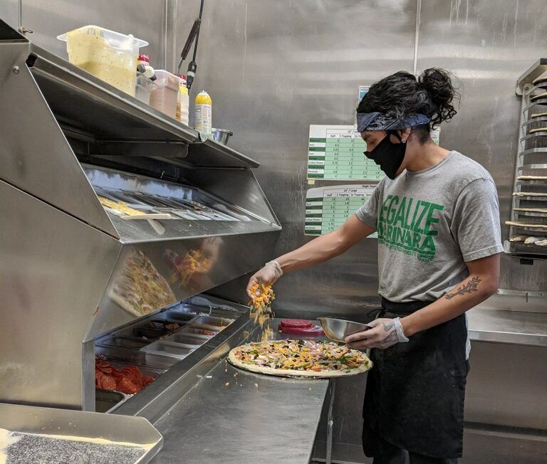 Gumby’s Pizza employee preparing pizzas, helping round up meal donations for Meals 4-One and All. As of April 29, Gumby’s Pizza has donated 580 meal vouchers which can be redeemed for a medium cheese or pepperoni pizza.
