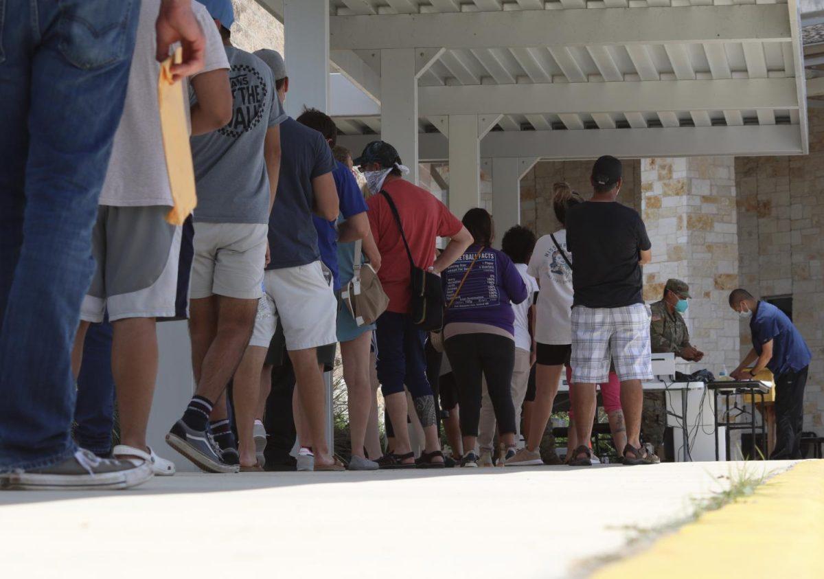 A line to get tested for COVID-19 forms, Sunday, June 14, 2020, outside of Bonham Pre-K school.