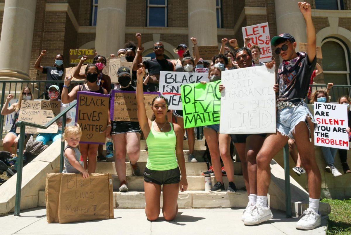 Protesters at an event primarily organized by Texas State student Malina Sutton pose for a photo in front of the Hays County Historic Courthouse, Wednesday, June 10, 2020, in San Marcos.