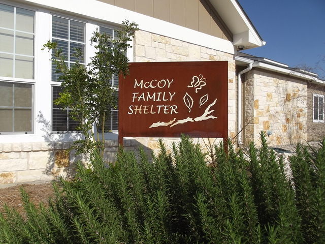 A burgundy sign with butterflies and leaves. that reads “McCoy Family Shelter” is the first greeting visitors and residents receive when entering Hays-Caldwell Women’s Center. (Photo courtesy of Melissa Rodriguez )