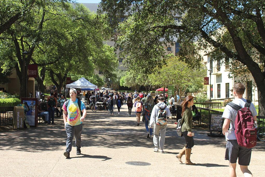 A+file+photo+of+Texas+State+students+walking+through+the+Quad.