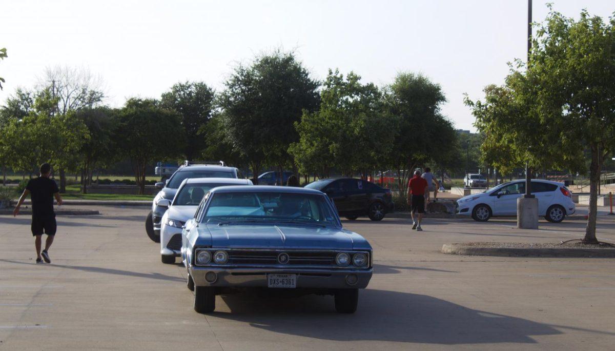 The parked caravan waits outside the Hays County Government Center as protestors gather to listen to speakers, Friday, July 17, 2020, in San Marcos.