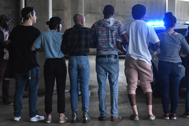 In an emotionally charged confrontation with UPD April 16, 2018, several students locked arms in front of a police cruiser. Students demanded answers from the student representative being escorted after he voted not to impeach Student Government president Connor Clegg for racially his insensitive Instagram posts. (Carrington Tatum)