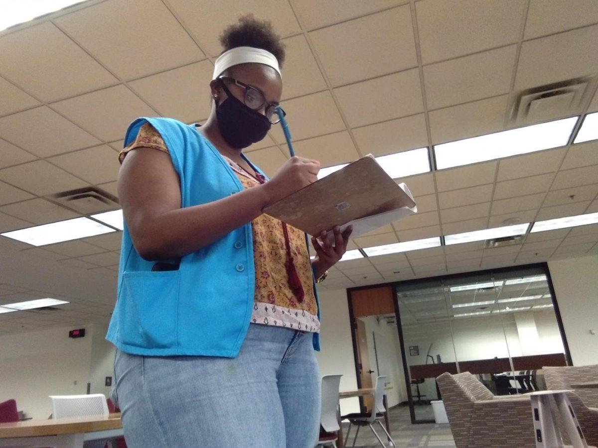 Texas State international studies senior Alexis Taylor takes count of students on a floor, Tuesday, July 21, 2020, in Alkek Library. Taylor makes timely rounds on each floor to make sure students in the library are wearing masks and following social distancing protocols.