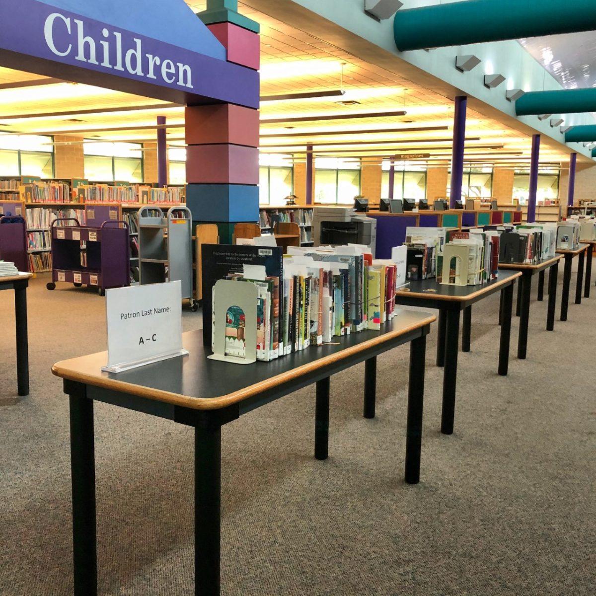 Books lined up for front porch pick-up at the San Marcos Public Library. The library’s front porch pickup service is open 11 a.m.-1 p.m. and 4-6 p.m., Monday-Saturday, as well as Sunday from 4-6 p.m. (Photo courtesy of San Marcos Public Library)