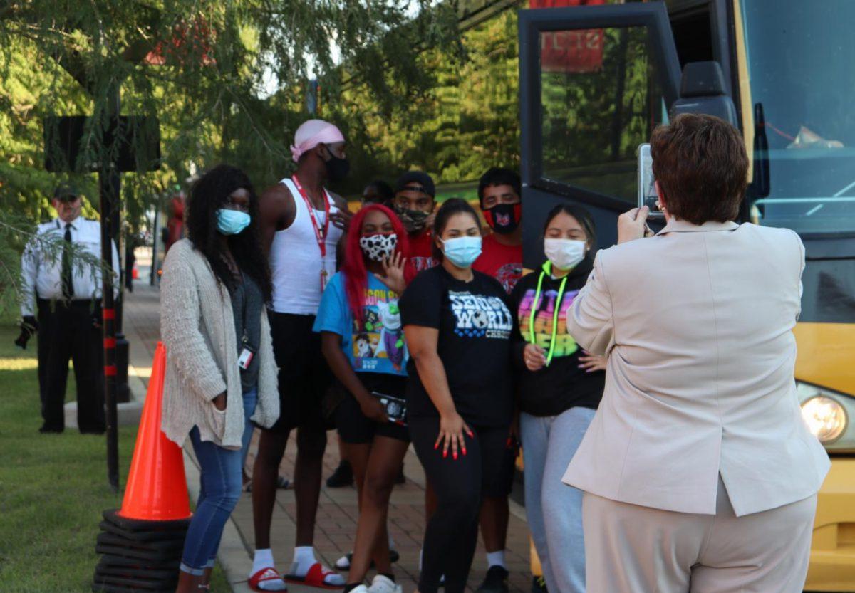 Interim Vice President of Student Affairs Mary Ellen Cavitt (right) takes a photo of students from Lamar University after they arrived at Texas State, Tuesday, Aug. 25, 2020, outside of the Performing Arts Center.