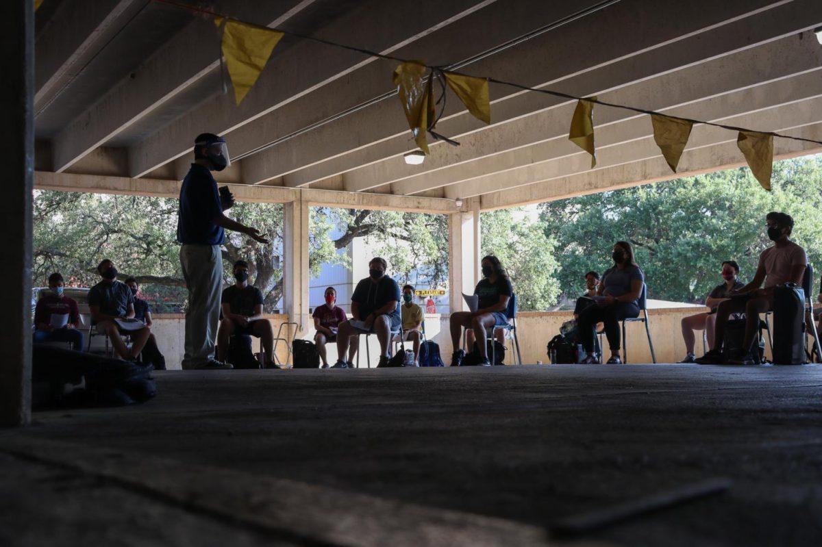 An instructor teaches their class outside, Monday, Aug. 24, 2020, in the Pleasant Street Garage. Many instructors opted to teach their classes outside with chairs spread apart in an effort to increase social distancing.