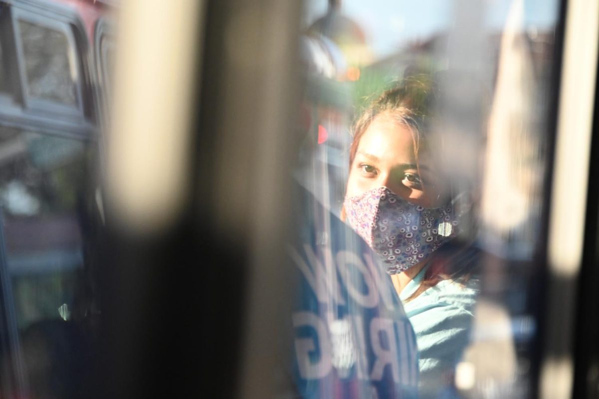Texas State nursing major Jovana Pena listens to nursing major George Castillo, Tuesday, Aug. 25, 2020, on a Bobcat Shuttle. The two sat a seat away from each other in accordance with the shuttle’s social distancing policy.