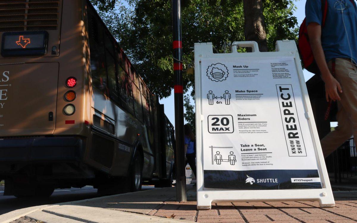 A sign with guidelines for riding Texas State shuttles is posted, Monday, Aug. 24, 2020, at the Quad bus loop as students get on and off the shuttles. Only 20 passengers are allowed on one shuttle at a time and seats are marked off to maintain distancing between passengers.