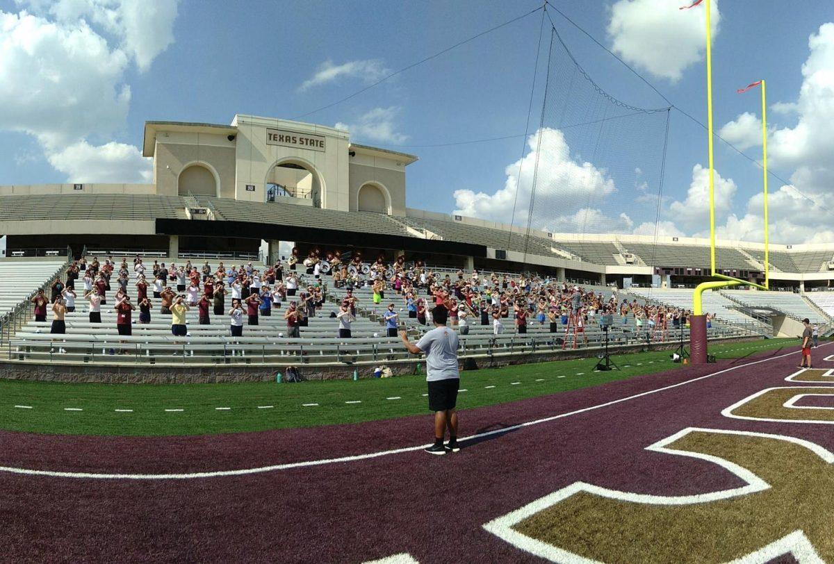 The Bobcat Marching Band rehearses in the bleachers, Monday, Aug. 31, 2020, at Bobcat Stadium. Members are spaced out from one another to follow social distancing guidelines.