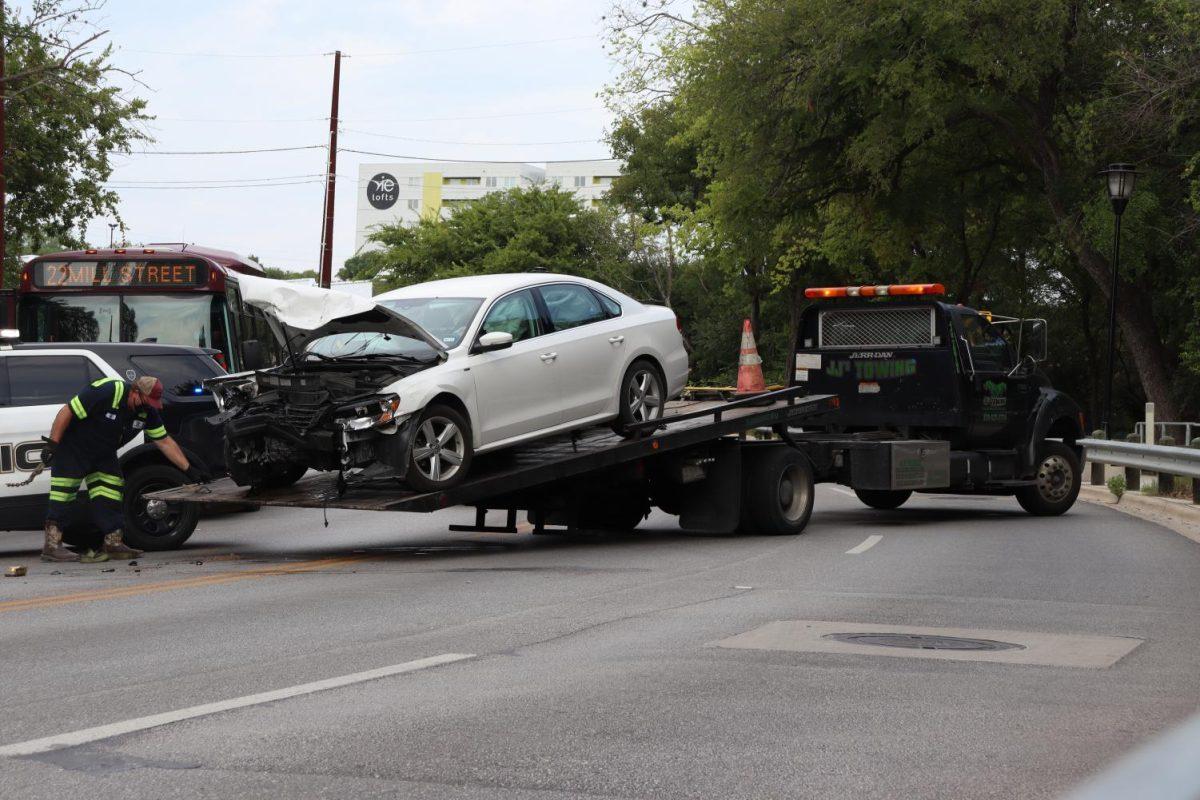 A newer-model Volkswagen involved in a two-car collision is towed onto the back of a trailer bed, Thursday, Sept. 17, 2020, on E Sessom Drive near Pleasant Street.