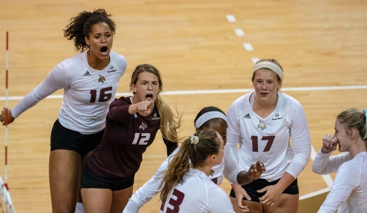 Texas State volleyball players celebrate a 2019 conference win against Louisiana, Friday, Sept. 27, 2019, at Strahan Arena.