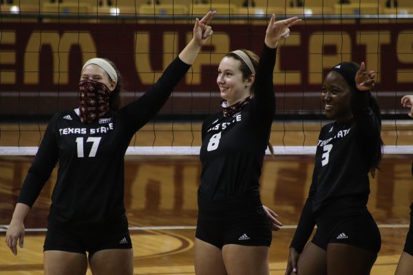 Texas State junior setter Emily DeWalt (17), junior middle blocker Jillian Slaughter (8) and senior middle blocker Tyeranee Scott (3) stand during the Texas State Alma Mater after winning against the University of Louisiana at Monroe, Friday, Sept. 25, 2020, at Strahan Arena. Texas State won 3-0 against the Warhawks.