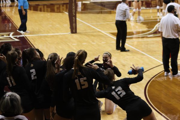 The Texas State women's volleyball team pretends to take a snapshot during a celebration routine on the sidelines of a game against the University of Louisiana at Monroe, Friday, Sept. 25, 2020, at Strahan Arena. Texas State won 3-0 against the Warhawks.