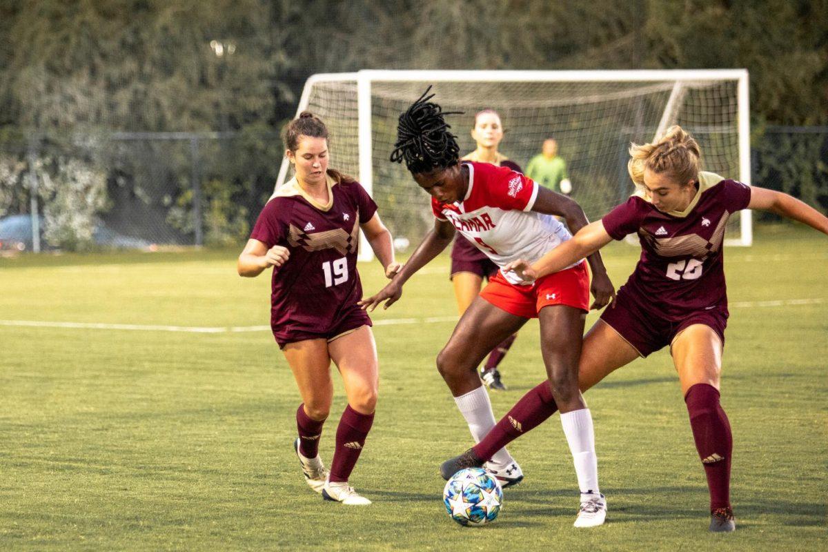 Texas State sophomore midfielder Lindsey Salisbury (26) kicks the soccer ball from under Lamar redshirt senior forward Esther Okoronkwo (9) while Texas State freshman midfielder Haley Shaw (19) tries to block Okoronkwo, Friday, Sept. 11, 2020, at the Bobcat Soccer Complex.