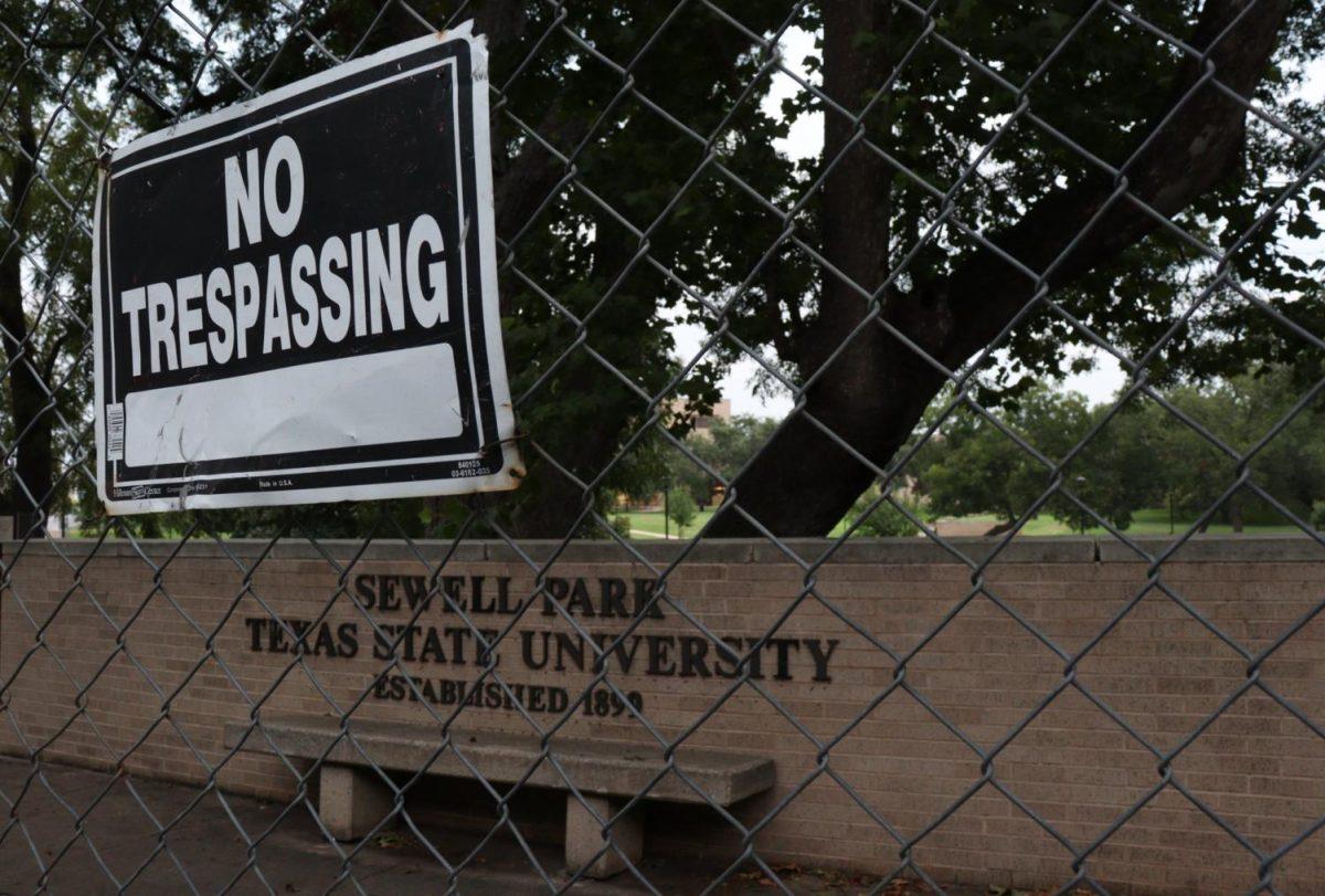 A ‘No Trespassing’ warning sign is posted on a fence, Wednesday, Sept. 2, 2020, outside of Sewell Park.