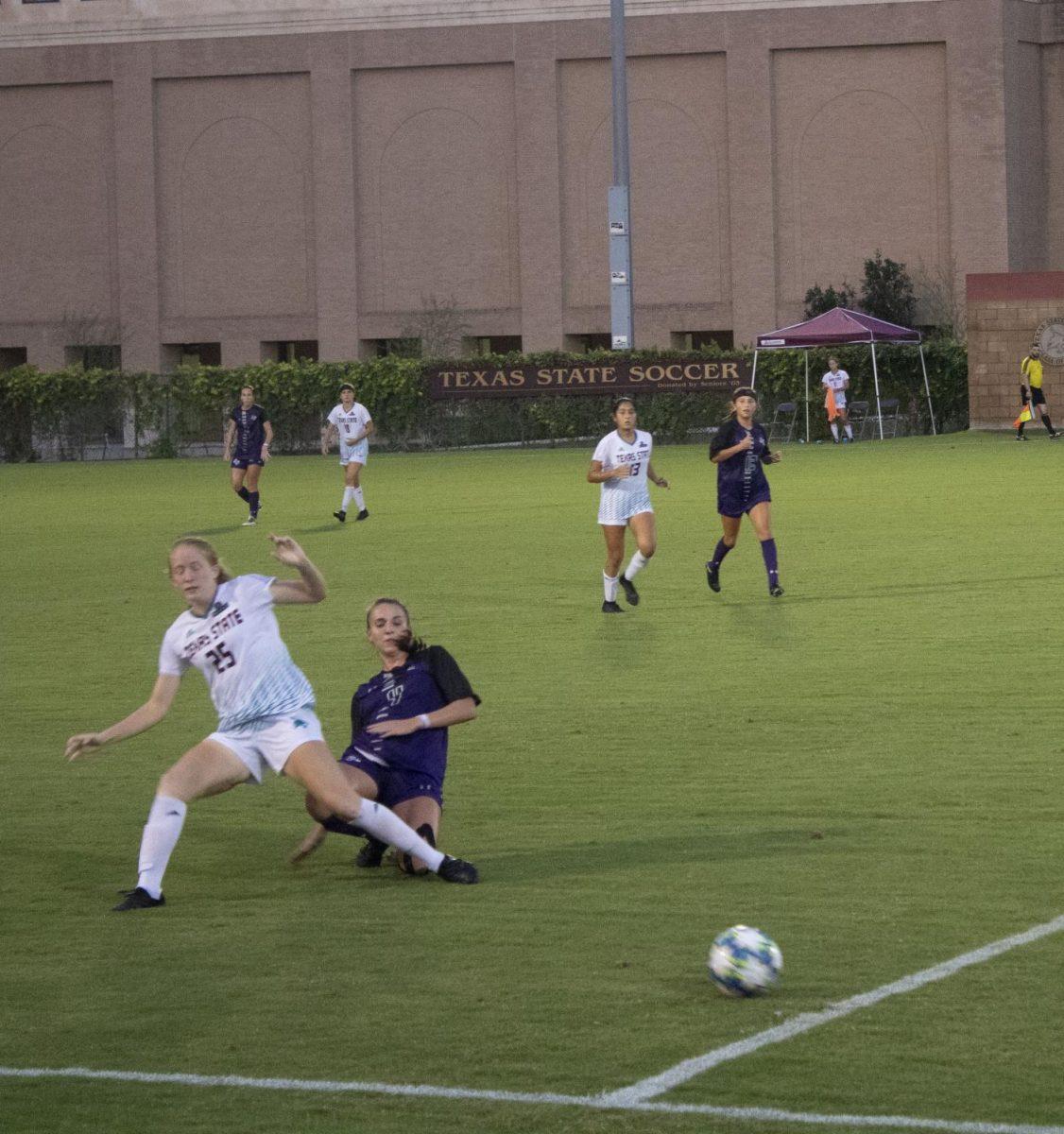 In her collegiate debut, freshman midfielder Emma Jones (25) is knocked down from retrieving the ball in a game against Stephen F. Austin Friday, Sept. 4. 2020 at the Bobcat Soccer Complex.