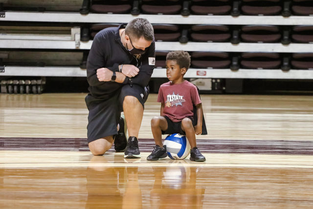 Volleyball+Head+Coach+Sean+Huiet+kneels+down+to+talk+to+his+son+Declan+during+the+Bobcats+volleyball+practice%2C+Wednesday%2C+Oct.+8%2C+2020%2C+at+Strahan+Arena.