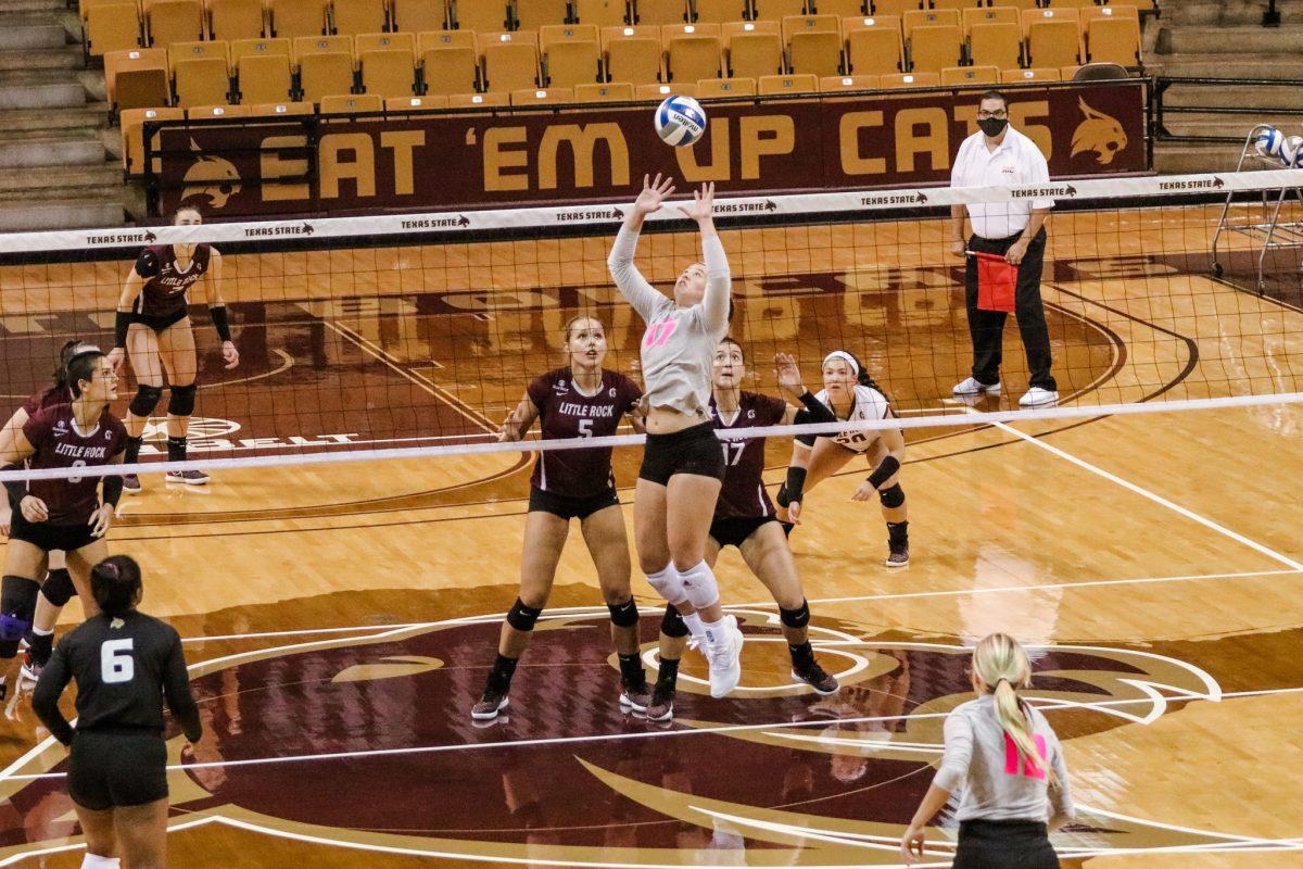 Texas State junior setter Emily DeWalt (17) jump sets the ball to an approaching hitter during the first set of a game against the University of Arkansas at Little Rock, Friday, Oct. 23, 2020, at Strahan Arena. The Bobcats won 3-1 against the Trojans.