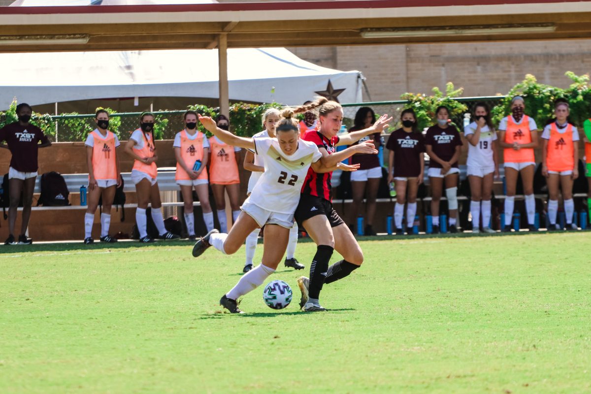 Texas+State+junior+defender+Addison+Gaetano+%2822%29+pushes+back+an+Arkansas+State+defender+as+she+dribbles+the+ball+down+the+field%2C+Saturday%2C+Oct.+10%2C+2020%2C+at+Bobcat+Soccer+Complex.+The+Bobcats+lost+1-0+in+overtime.