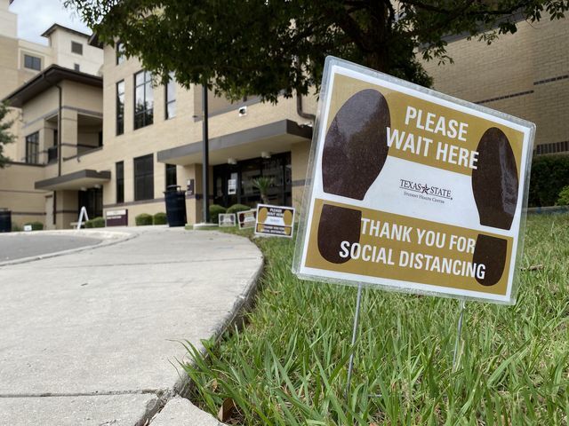 Social distancing signs outline the sidewalk to the Student Health Center, Thursday, Oct. 8, 2020, on Texas State campus. As the flu season approaches, the center has held multiple outreach events to give students, faculty and staff the opportunity to receive a flu shot on campus.