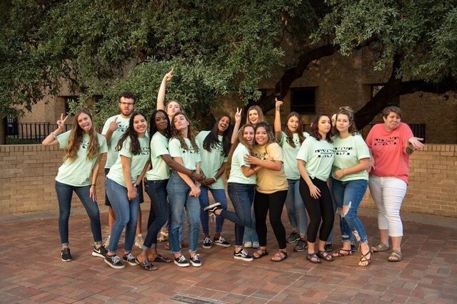 Surrounded by a team of mentors she supervises as a lead, Brenda Manzano stands out in the middle of the group wearing a yellow t-shirt during a group photo with the PACE Peer Mentors.