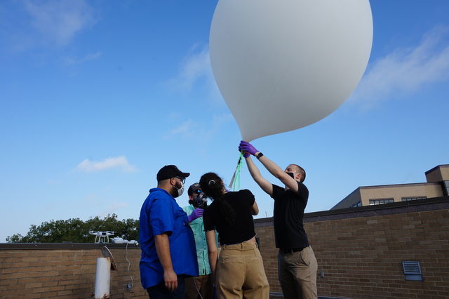 Four members from Society for Space Exploration (SSE) fill up a big white weather balloon on the roof of the Supple Science Building, Saturday, Aug. 29, 2020, at Texas State University. This experiment was known as Icarus-1 and was the first step in SSEs mission of building a low earth-orbiting satellite.