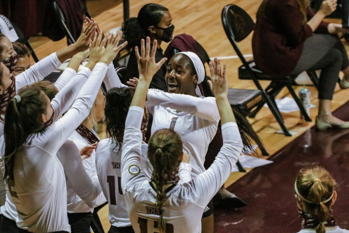 Texas State volleyball junior outside hitter Kenedi Rutherford (1) high fives her teammates as she comes off the court during a game against the University of Louisiana at Monroe, Saturday, Sept. 26, 2020, at Strahan Arena. The Bobcats won all three games against the Warhawks this weekend.