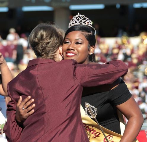 Texas State Homecoming Queen Nakenya Minnieweather hugs President Denise Trauth, Saturday, Nov. 9, 2019, during halftime of Texas States homecoming football game vs. South Alabama at Bobcat Stadium.