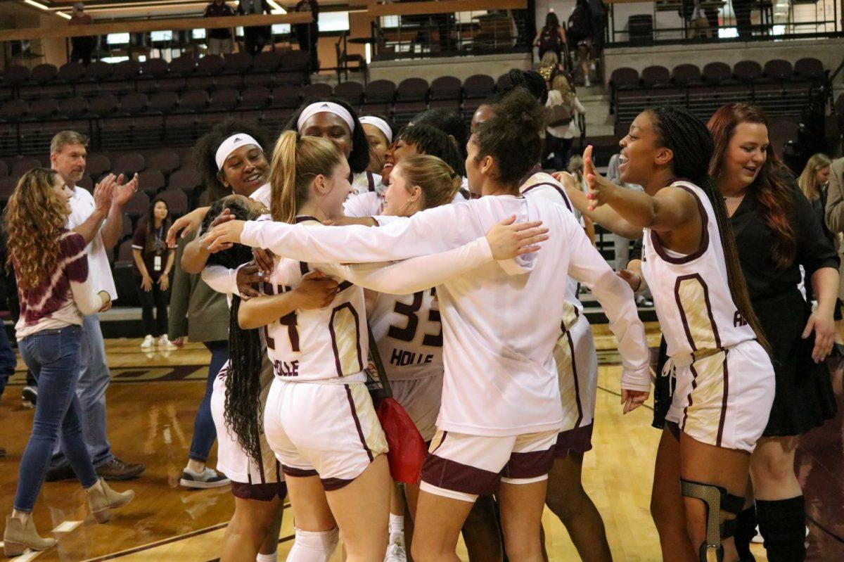The Texas State women’s basketball team surrounds seniors Brooke and Bailey Holle as they are celebrated on their senior night, Saturday, Feb. 29, 2020 at Strahan Coliseum.