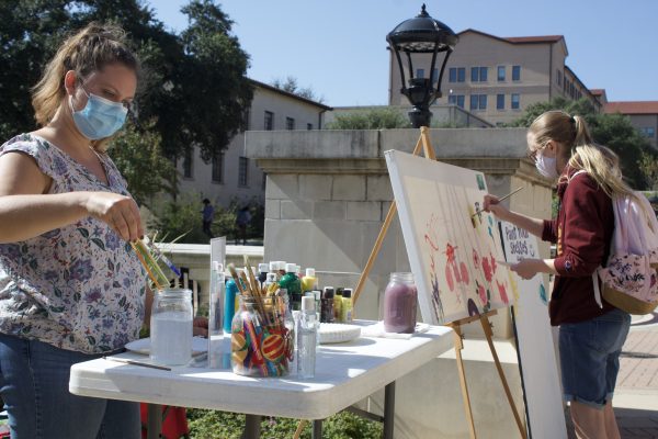 Kamryn Zelle (right) paints at a booth on campus put together by Kiley Hyman (right) and Megan Farnell (not pictured), Wednesday, Nov. 11, 2020, at Texas State. Hyman and Farnell are members of the Texas State Baptist Student Ministry and put the booth together with the organization to "help students destress and to spread the love of Christ."