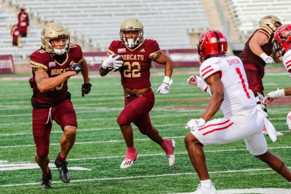 Texas State freshman running back Calvin Hill (22) carries the ball around Arkansas State defenders to gain yards for the Bobcats, Saturday, Nov. 21, 2020, at Bobcat Stadium. Texas State won 47-45.
