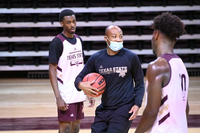 Texas State sophomore guard Drew Tennial (10) and freshman guard Dylan Dawson (0) listen to Interim Head Coach Terrence Johnson during practice, Friday, Nov. 6, 2020, at Strahan Arena.