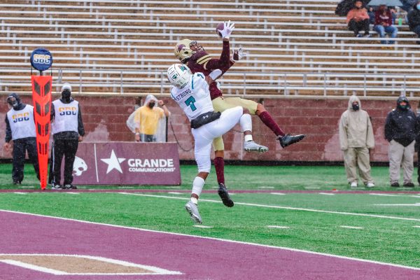 Texas State junior wide receiver Javen Banks (12) jumps over a Coastal Carolina University junior cornerback D'Jordan Strong (7) to catch the ball and score the first touchdown of the game for the Bobcats, Saturday, Nov. 28, 2020, at Bobcat Stadium. The Bobcats lost 49-14.
