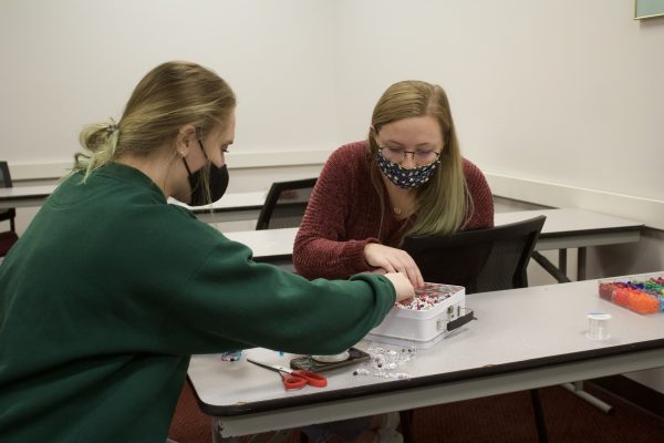 Texas State finance freshman Karli Smith (right) and mass communication freshman Kylie Cox (left) take a break and make arts and craft bracelets, Tuesday, Nov. 3, 2020, during Boko’s Election Watch Party at the LBJ Student Center Teaching Theater. Attendees could go to designated rooms for activities to help destress throughout the event.
