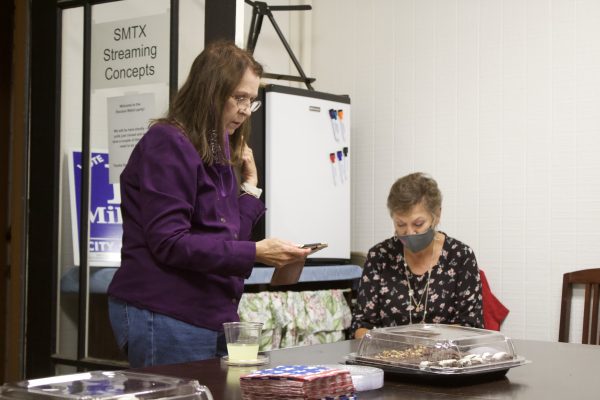 Mayor Jane Hughson (left) reads out the results of the Hays County election as Marsha Moore (right) records the numbers on a chart during an election watch party held by Hughson, Tuesday, Nov. 3, 2020 in San Marcos. Hughson is the incumbent mayor running for reelection against four other candidates.
