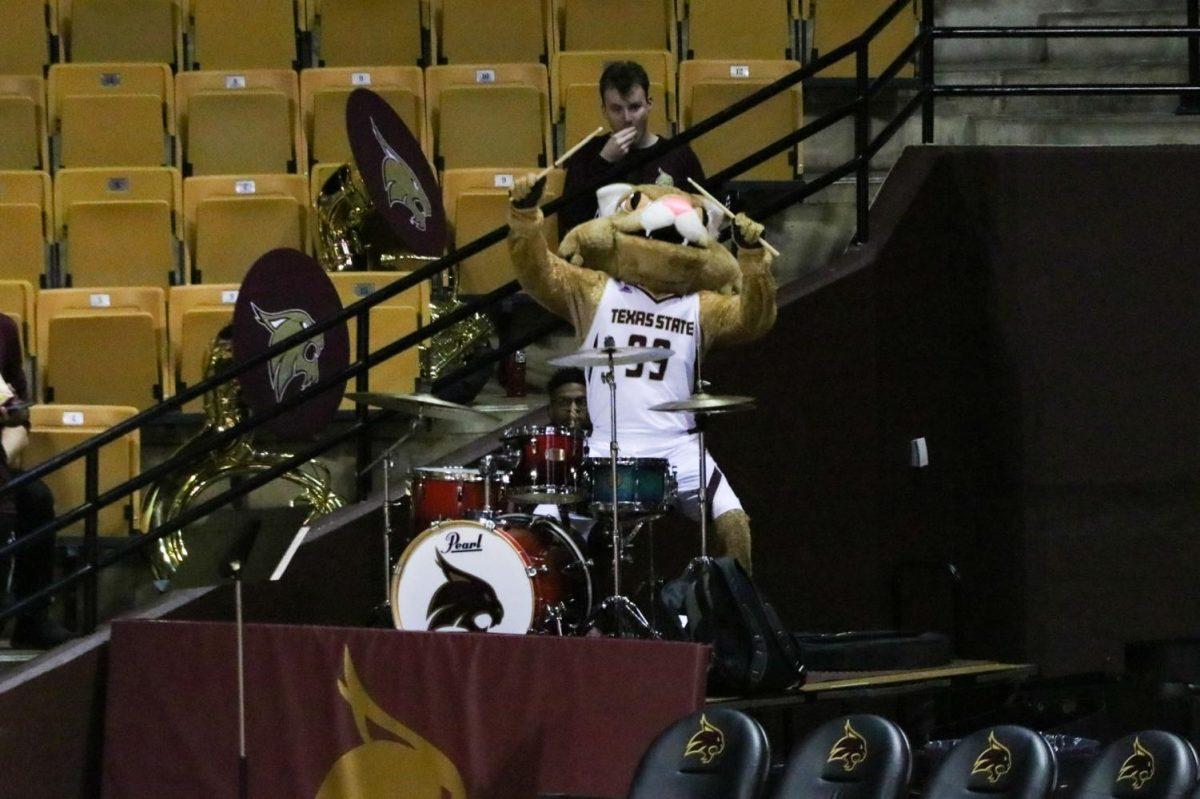 Boko the Texas State mascot jokingly plays the drums with the Texas State band while cheering on the women’s basketball team, Saturday, Feb. 29, 2020, at Strahan Coliseum.