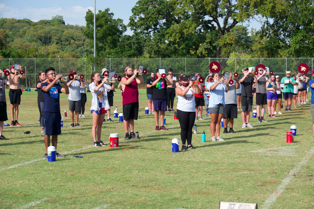The Bobcat Marching Band rehearses music, Wednesday, Oct. 7, 2020, at a practice field outside Strahan Arena.