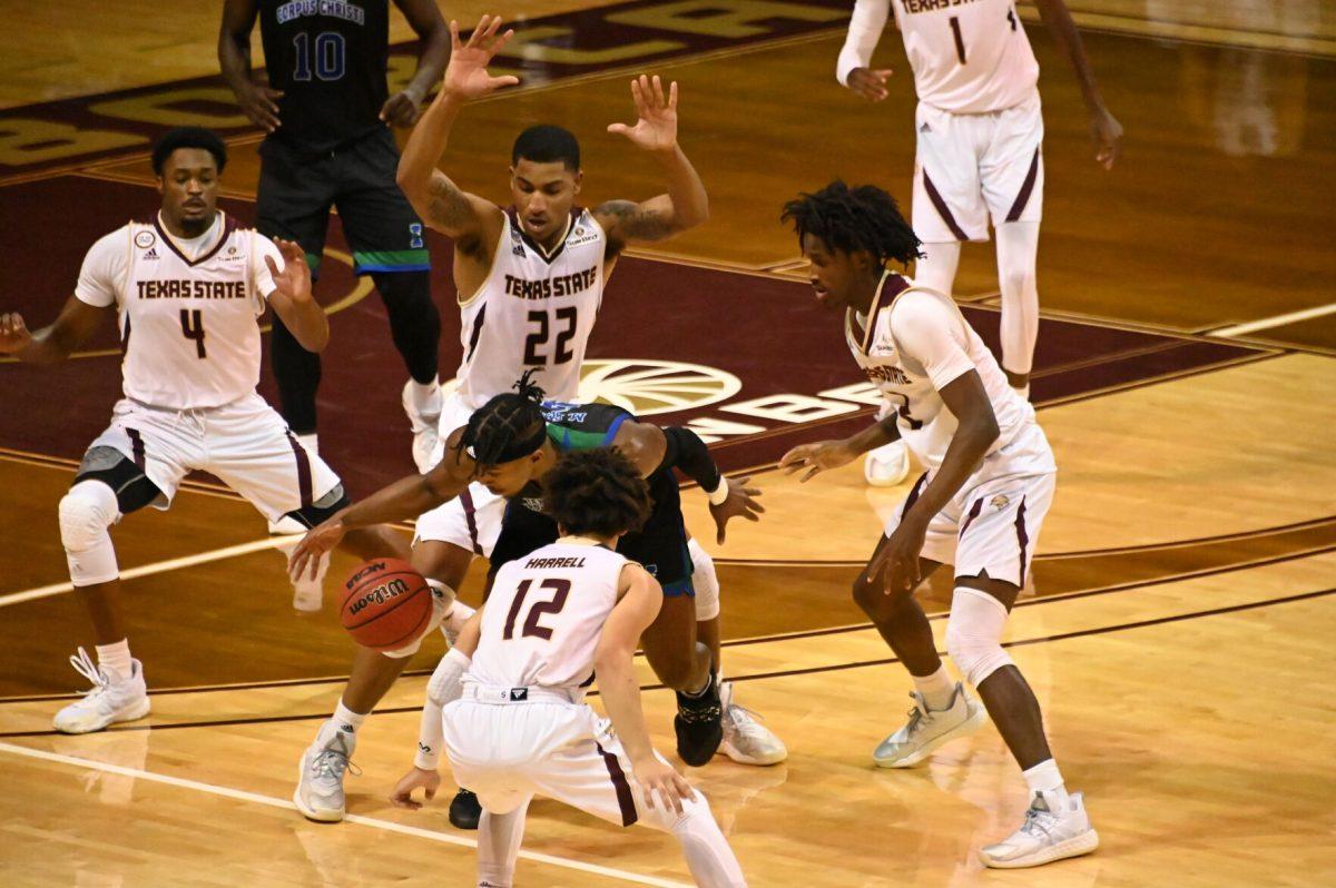 Texas A&M Corpus Christi senior guard Myles Smith (2) dribbles while being defended by four Texas State players, Tuesday, Dec. 15, 2020, at Strahan Arena. Texas State won the game 51 - 46.