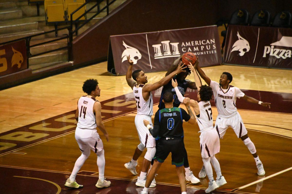 Texas A&M Corpus Christi senior forward Perry Francois (10) fights against the Texas State defense, Tuesday, Dec. 15, 2020, at Strahan Arena. Texas State won the game 51 - 46.