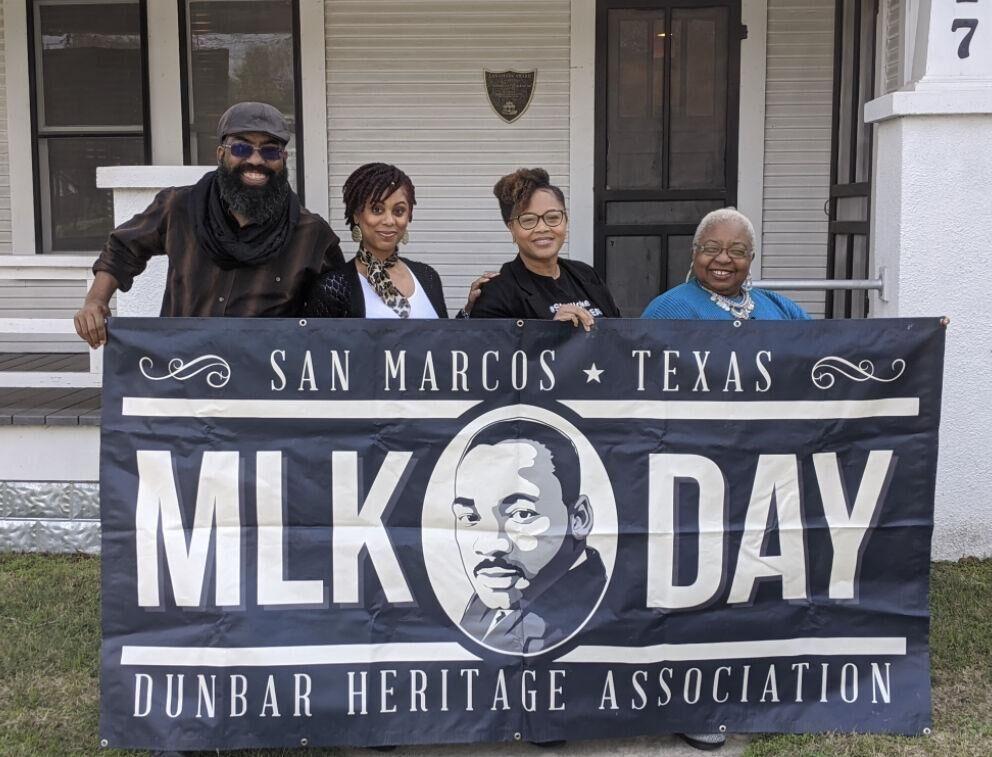 (Left to right) Alex Banbury, Jonafa Banbury, Claudea Blythe and Mittie Miller stand with a “MLK Day” banner at a past MLK celebration event.