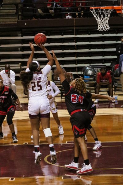 Texas State sophomore forward Lauryn Thompson (25) shoots the basketball over defenders during the first quarter of the game against the University of Louisiana at Lafayette, Friday, Jan. 1, 2021, at Strahan Arena. The Bobcats won 71-63.