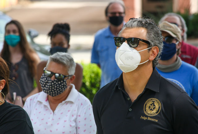 Hays County Judge Ruben Becerra listens to a speech at a protest held for and in honor of George Floyd and Breonna Taylor, Friday, May 29, 2020, at the Hays County Historic Courthouse.