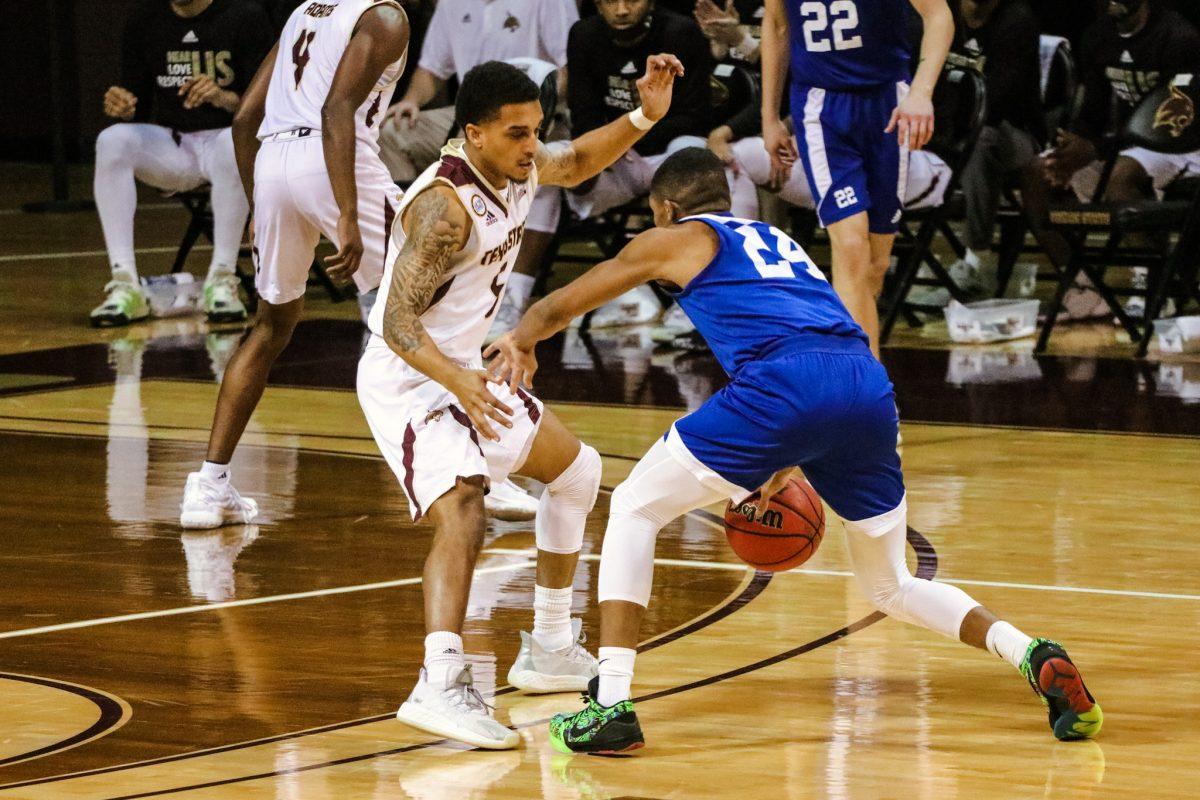 Texas State graduate guard Marlin Davis (5) guards Our Lady of the Lake senior guard Ethan White (24) as he dribbles down the court, Saturday, Dec. 12, 2020, at Strahan Arena. The Bobcats lost 61-58.